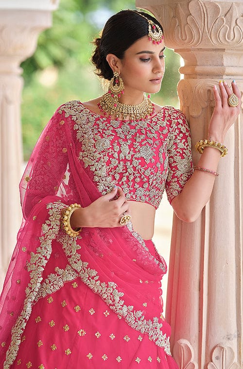 Bride wearing a pastel pink lehenga with a yellow dupatta and emerald  jewellery. | Pink bridal lehenga, Indian wedding dress designers, Indian  bridesmaid dresses